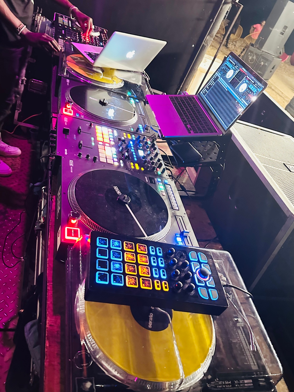 Illuminated DJ controls during an event